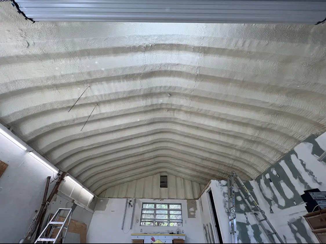 Spray polyurethane foam applied to the underside of a metal roof deck in Highland Village